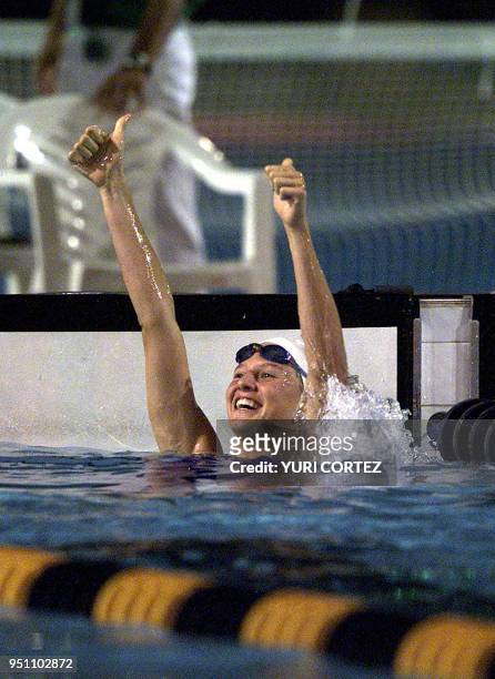 The Guatemalan Gisella Morales celebrates after winning the gold medal 29 November 2002 in the 200 meter reverse style swimming competition of the...