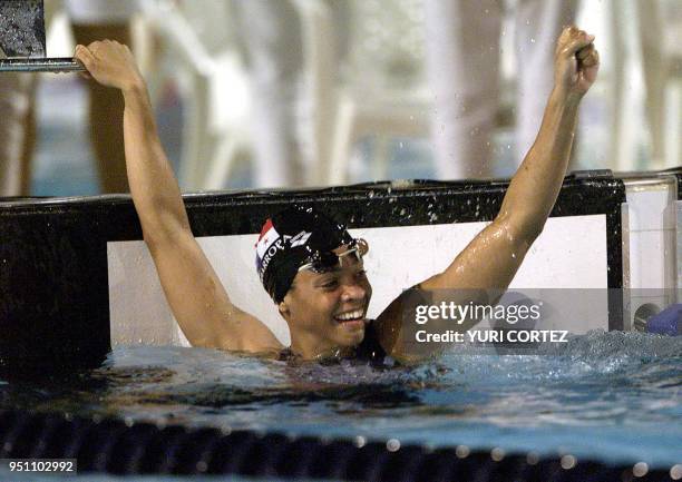 The Panamanean Eileen Coparropa celebrates, 29 November 2002, after winning the gold medal in the 50 meter freestyle swimming competition of the...