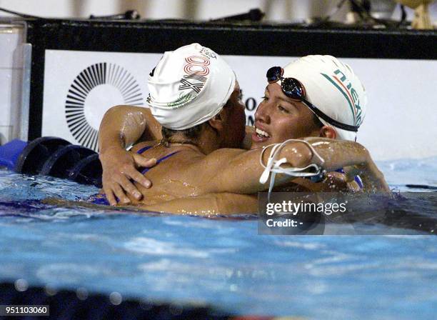 The Mexicans Tania Galindo and Claudia Farias hug each other, 28 November 2002, after winning the gold medal in the 800 freestyle swimming...