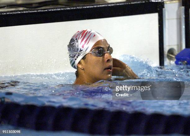 The Mexican Paola Espana observes the stopwatch, 27 November 2002, after participating in the 100 meter butterfly swimming competition in the XIX...