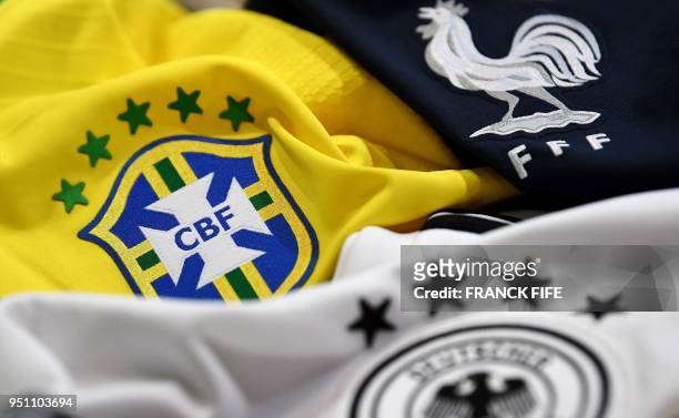 Picture taken on April 25, 2018 in Paris, shows the jersey of the Brasilian, German and French national football team for the FIFA 2018 World Cup...