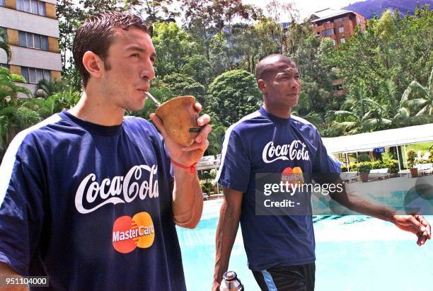 Joe Bizera is drinking an herbal drink, while walking next to Richard Morales of Uruguay at their hotel 17 July 2001 in Medellin, Colombia. Uruguay...