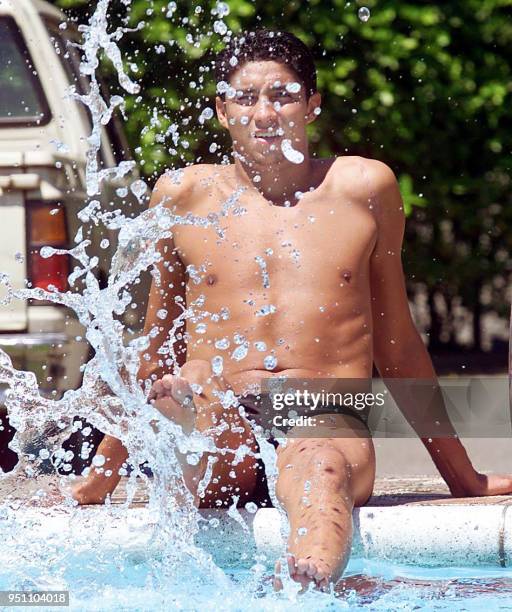 Brazilian soccer player Jardel does poolside relaxation exercises during team practice, 16 July 2001 in Cali, Colombia. Brazil is set to face...