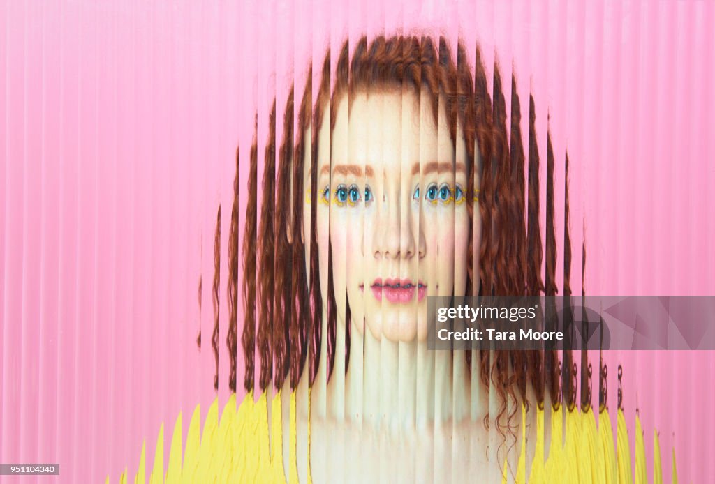 Female face obscured behind glass