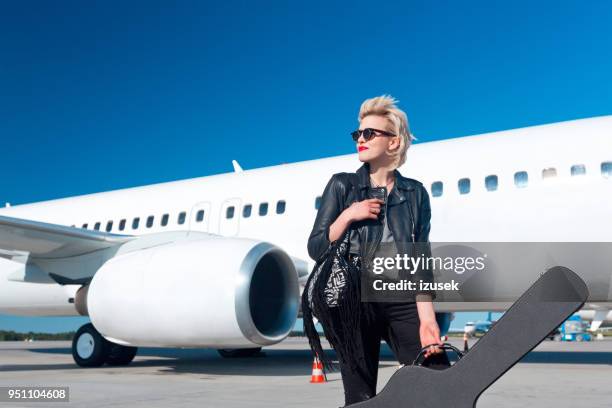 female rockstar on airport - passenger musician stock pictures, royalty-free photos & images