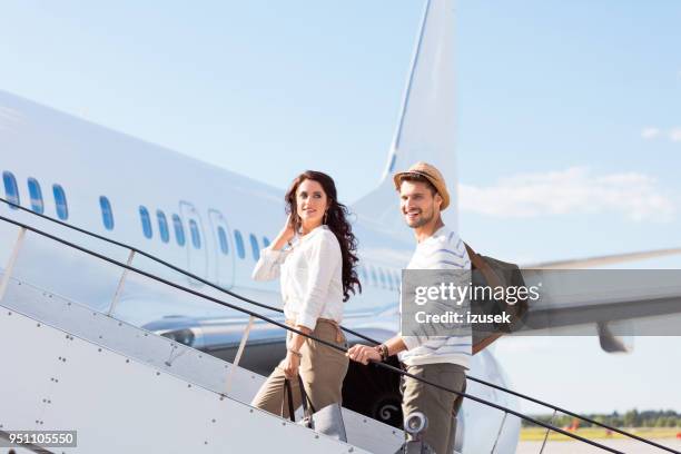 couple leaving for a vacation - couple airport stock pictures, royalty-free photos & images