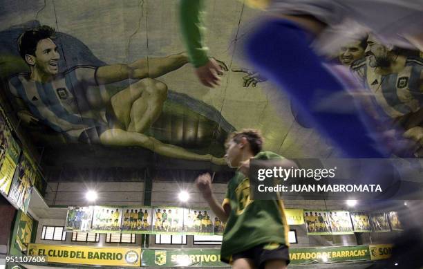 Children play indoor football at Sportivo Pereyra de Barracas football club in Buenos Aires, on April 24 where local artist Santiago Barbeito created...