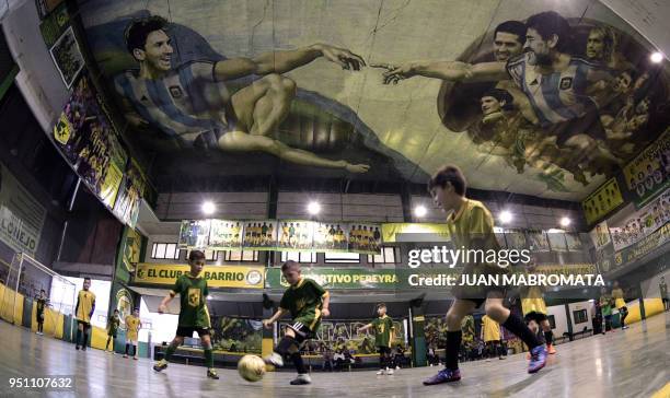 Children play indoor football at Sportivo Pereyra de Barracas football club in Buenos Aires, on April 24 where local artist Santiago Barbeito created...