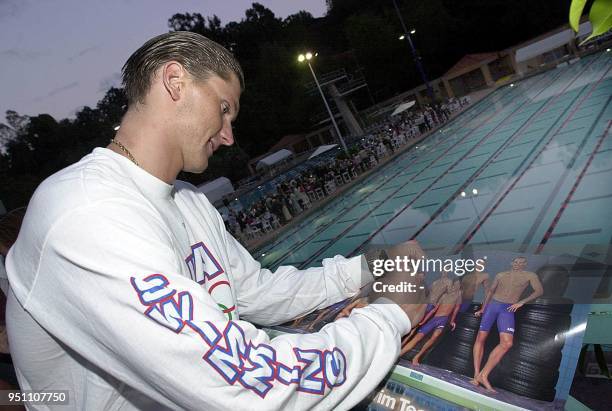 Olympic Swim Team member Russian-born Lenny Krayzelburg signs a photograph for fans at an Olympic Send-Off Gala at the Rose Bowl Aquatics Center...