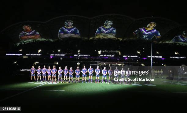 The Storm stand for a minutes silence during the round eight Anzac Day NRL match between the Melbourne Storm and New Zealand Warriors at AAMI Park on...