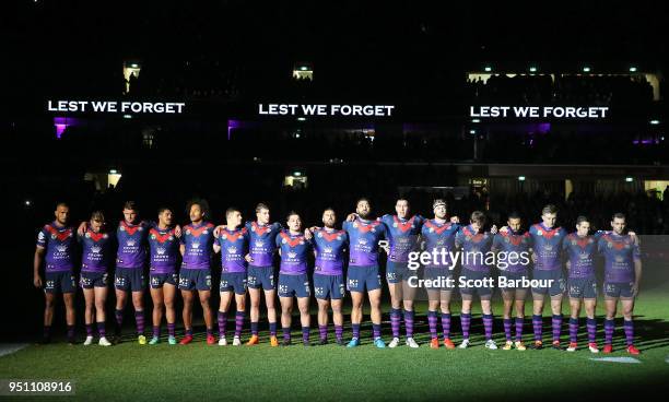 The Storm stand for a minutes silence during the round eight Anzac Day NRL match between the Melbourne Storm and New Zealand Warriors at AAMI Park on...