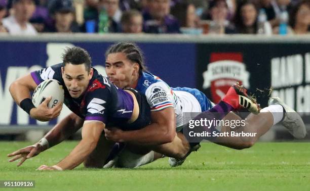 Billy Slater of the Melbourne Storm is tackled during the round eight NRL match between the Melbourne Storm and New Zealand Warriors at AAMI Park on...