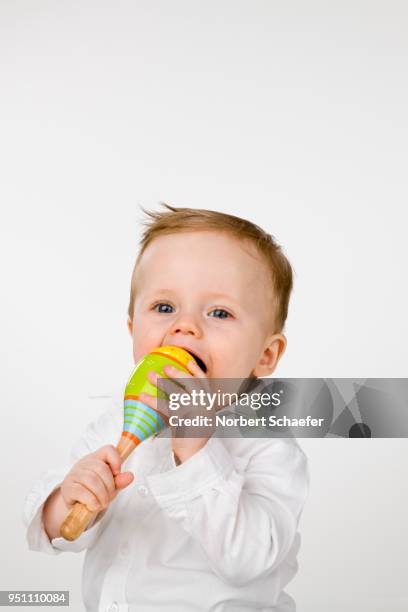 baby boy with maraca - chewing stock pictures, royalty-free photos & images