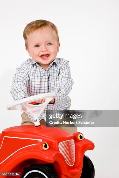 baby boy playing with toy car - bobbycar stock pictures, royalty-free photos & images