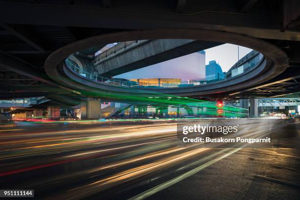 speed traffic - light trails on motorway highway at night, long exposure abstract urban background - long exposure light trails stock pictures, royalty-free photos & images