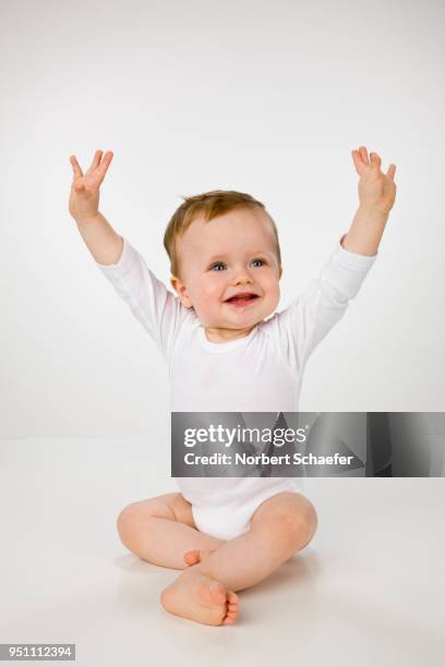 baby boy with arms in air - sparkdräkt bildbanksfoton och bilder