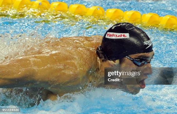 Swimmer Michael Phelps competes in the final of the men's 100-metre butterfly swimming event in the FINA World Championships at the indoor stadium of...