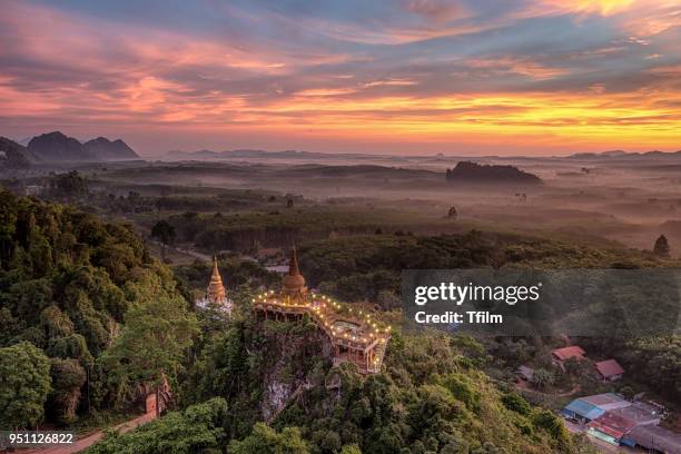 high view of khao na nai luang temple with the colorful sky in the morning at surat thani province, southern of thailand - surat thani province stock-fotos und bilder