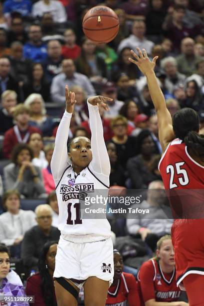 Roshunda Johnson of the Mississippi State Lady Bulldogs shoots the ball against Asia Durr of the Louisville Cardinals during the semifinal game of...