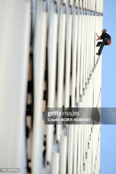 French climber Alain Robert climbs the front of the Ariane building, a 230 metre tower, on October 8, 2009 in La Defense, outside Paris. Alain...