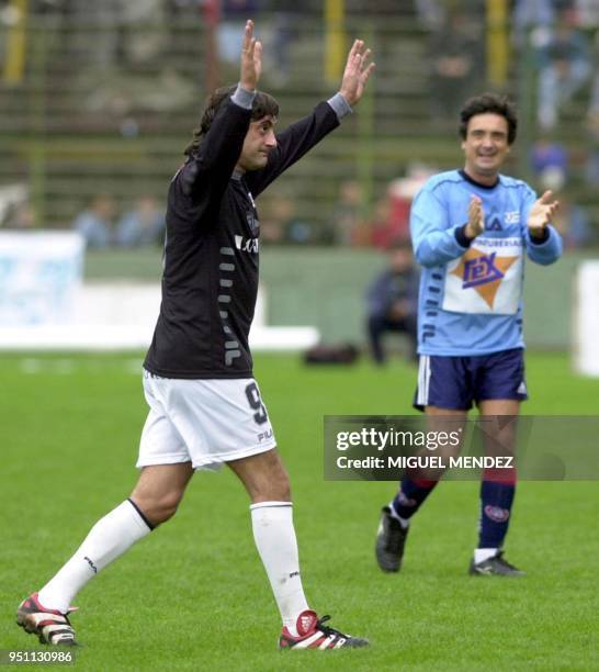 Enzo Francescoli ex- star of River Plate of Argentina and the Uruguayan national soccer team, exits the field as artist Nito Artaza applauds, in...