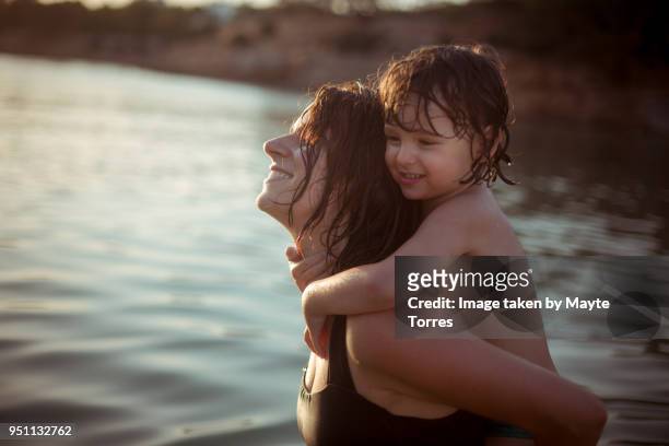 mom and toddler enjoying in the beach - hot spanish women stock pictures, royalty-free photos & images