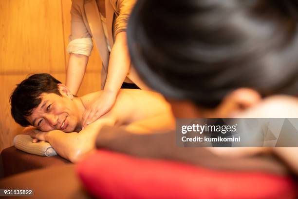 asian man and woman in relaxation salon - woman smiling facing down stock pictures, royalty-free photos & images