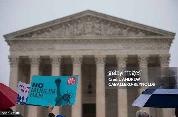 Activists rally against the Muslim Ban on the day the Supreme Court hears arguments in Hawaii v. Trump in front of the court in Washington, DC on...
