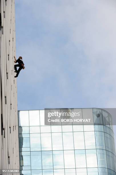 French climber Alain Robert climbs the front of the Ariane building, a 230 metre tower, on October 8, 2009 in La Defense, outside Paris. Alain...