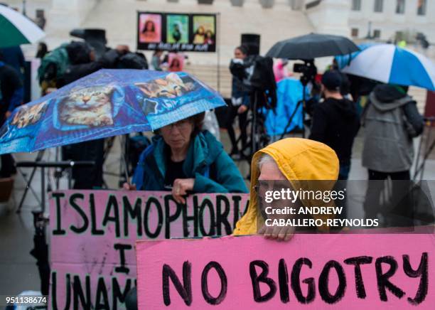 Activists rally against the Muslim Ban on the day the Supreme Court hears arguments in Hawaii v. Trump in front of the court in Washington, DC on...