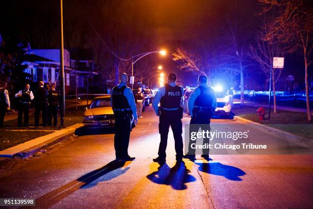 Police work the scene where two people were shot near the intersection of 60th and Maplewood Avenue Tuesday April 24, 2018 in Chicago.
