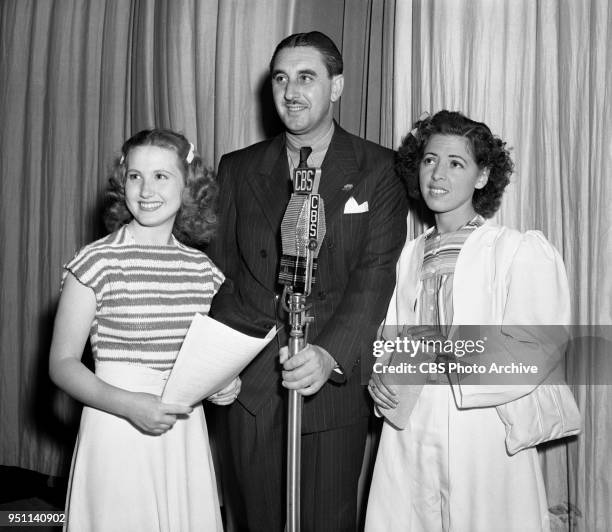 Radio program, Man About Hollywood. Broadcasts from CBS KNX studios at Columbia Square, Hollywood, CA. Pictured left to right: Linda Ware, a 13-year...