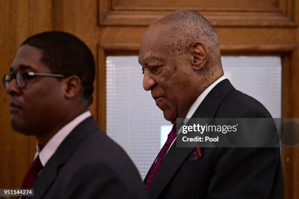 Bill Cosby, right, walks back to courtroom A, after a break, shortly after arriving for his sexual assault trial lead by spokesperson Andrew Wyatt at...