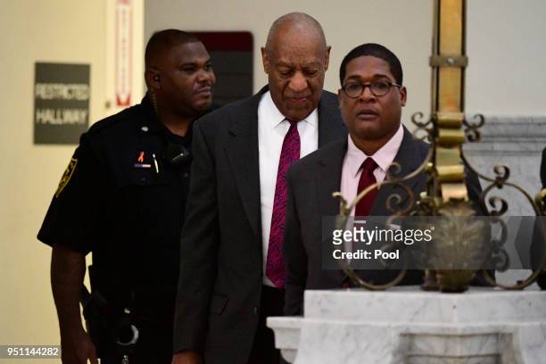 Bill Cosby, center, arrives from a short break after arriving for his sexual assault trial lead by spokesperson Andrew Wyatt, right, at the...