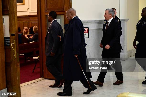 Bill Cosby, center, arrives for his sexual assault trial lead by spokesperson Andrew Wyatt at the Montgomery County Courthouse, on April 25 in...