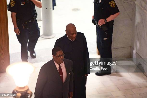 Bill Cosby, center, arrives for his sexual assault trial lead by spokesperson Andrew Wyatt at the Montgomery County Courthouse, on April 25 in...