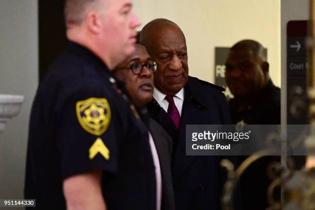 Bill Cosby, center, arrives for his sexual assault trial lead by spokesperson Andrew Wyatt, left center, at the Montgomery County Courthouse, on...