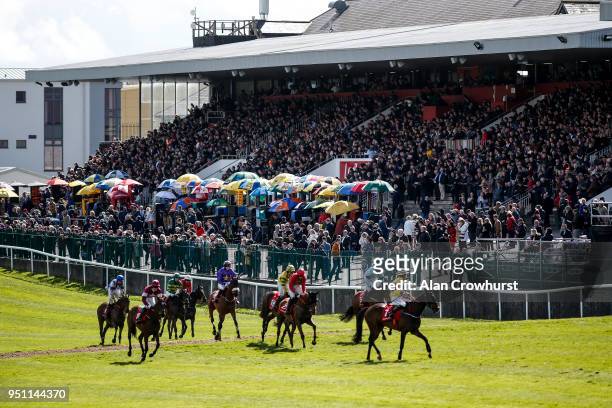 Large crowd look on as runners pull up after finishing at Punchestown racecourse on April 24, 2018 in Naas, Ireland.