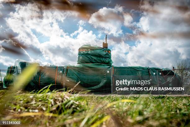Picture taken on April 25, 2018 shows the homemade submarine UC3 Nautilus as it is covered with green tarpaulin in Nordhavn, a harbour area in...