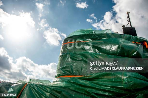 Picture taken on April 25, 2018 shows a detail of the homemade submarine UC3 Nautilus as it is covered with green tarpaulin in Nordhavn, a harbour...