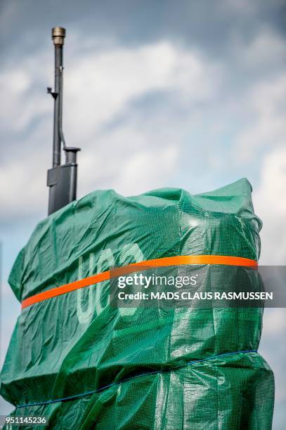 Picture taken on April 25, 2018 shows a detail of the homemade submarine UC3 Nautilus as it is covered with green tarpaulin in Nordhavn, a harbour...