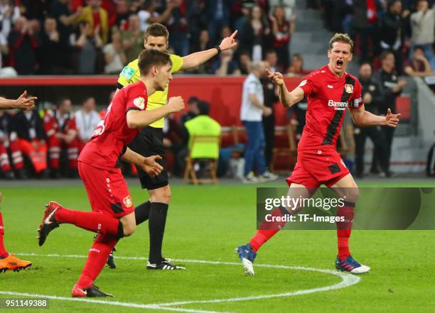 Lars Bender of Leverkusen celebrates after scoring his team's first goal with Panagiotis Retsos of Leverkusen during the DFB Cup semi final match...