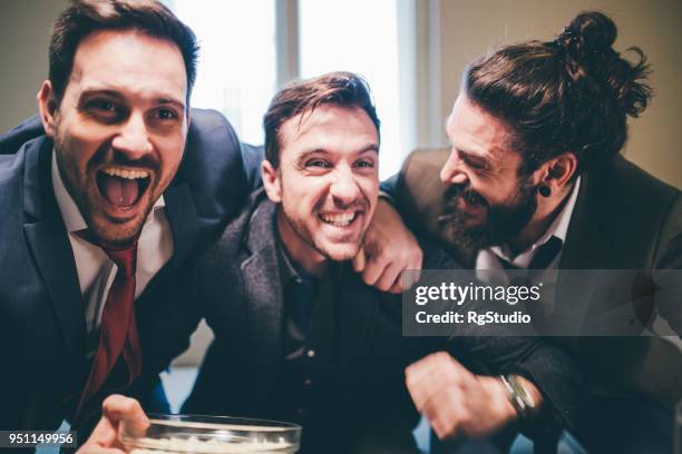business men hugging and supporting their favorite football teams in excitement - full suit stock pictures, royalty-free photos & images