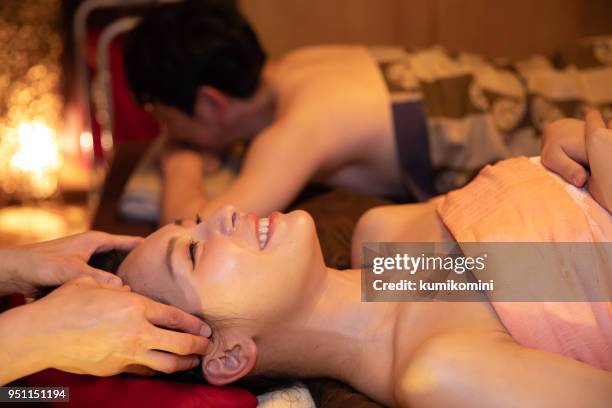 asian man and woman in relaxation salon - woman smiling facing down stock pictures, royalty-free photos & images
