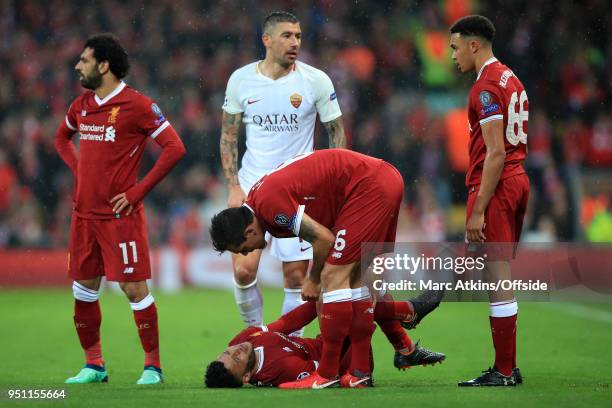 Dejan Lovren of Liverpool shows concern for the injured Alex Oxlade-Chamberlain during the UEFA Champions League Semi Final First Leg match between...