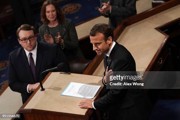 French President Emmanuel Macron acknowledges the crowd as he arrives at the House chamber to deliver an address to a joint meeting of U.S. Congress...