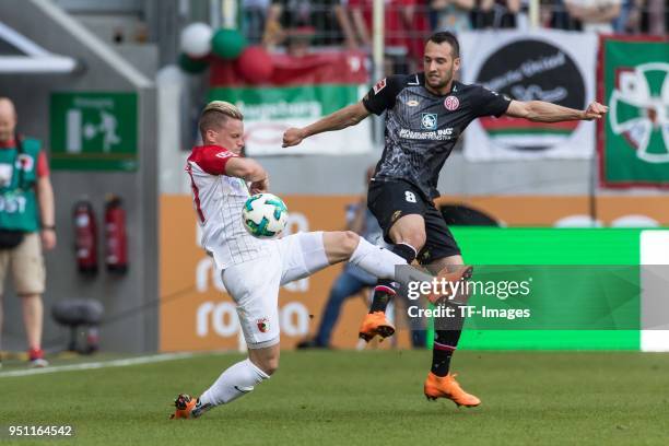 Philipp Max of Augsburg battle for the ball Levin Oeztunali of Mainz battle for the ball during the Bundesliga match between FC Augsburg and 1. FSV...