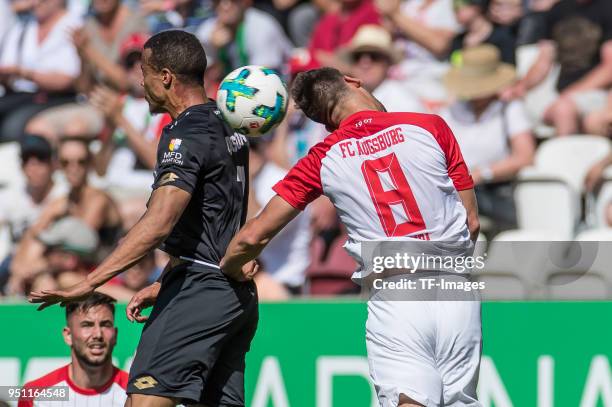 Robin Quaison of Mainz and Rani Khedira of Augsburg battle for the ball during the Bundesliga match between FC Augsburg and 1. FSV Mainz 05 at...