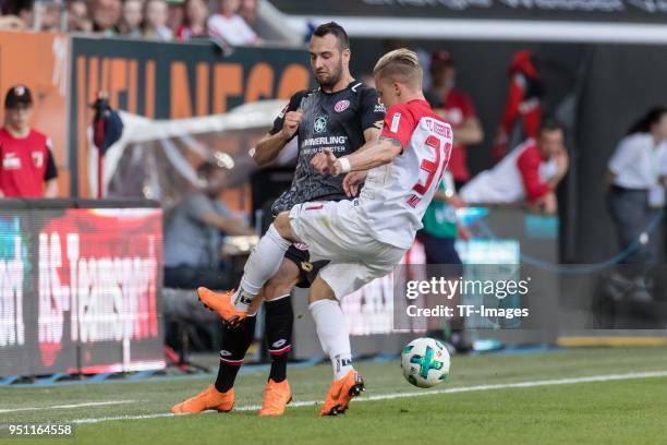 Levin Oeztunali of Mainz and Philipp Max of Augsburg battle for the ball during the Bundesliga match between FC Augsburg and 1. FSV Mainz 05 at...