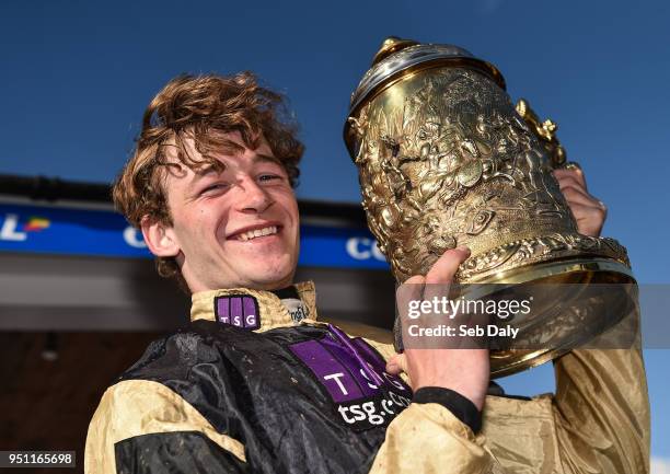 Naas , Ireland - 25 April 2018; Jockey David Mullins celebrates with the trophy after winning the Coral Punchestown Gold Cup on Bellshill at...